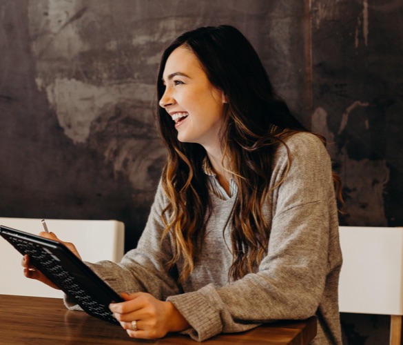 Individual in a cafe in front of a laptop